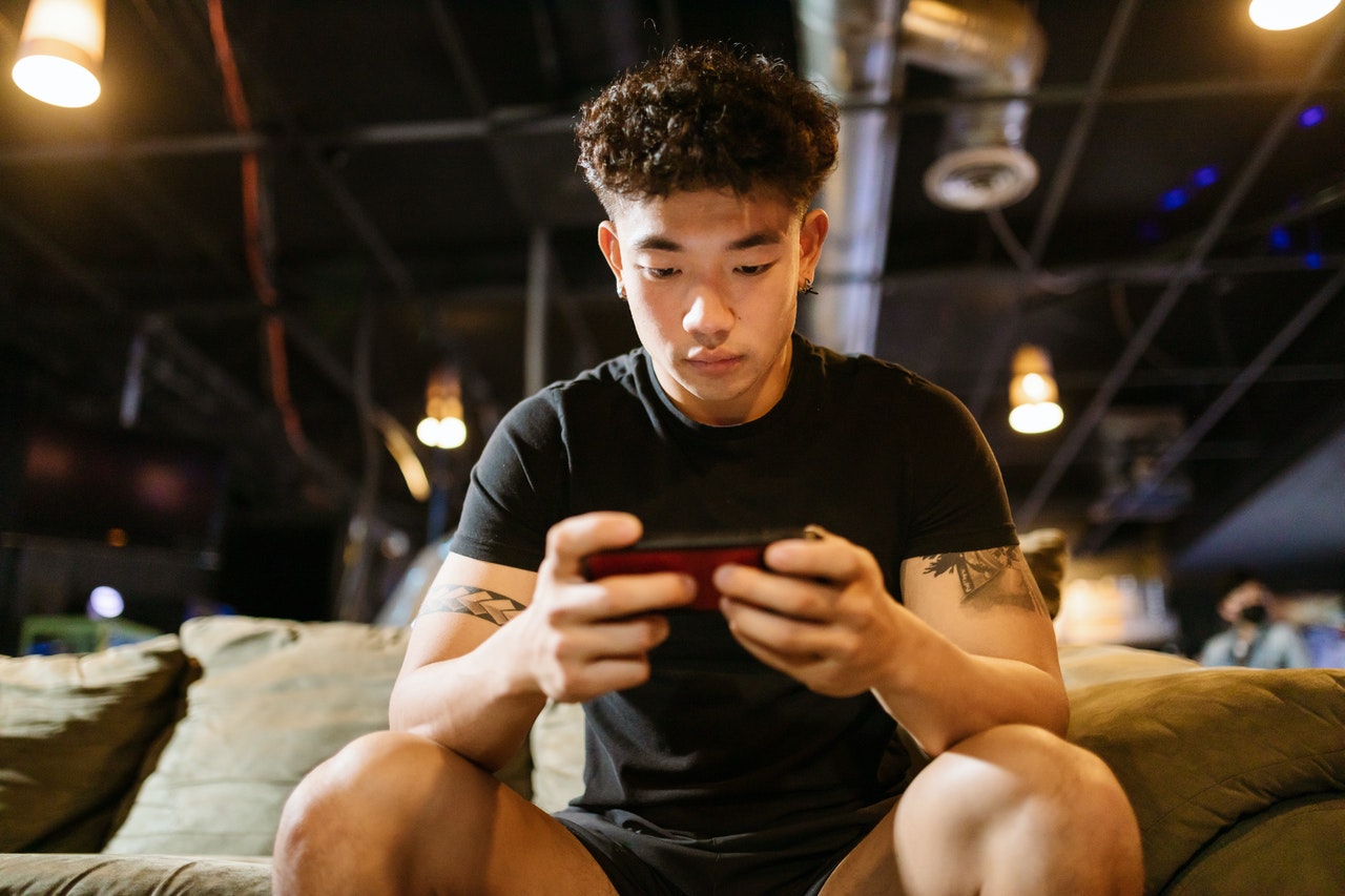 Young man playing mobile games